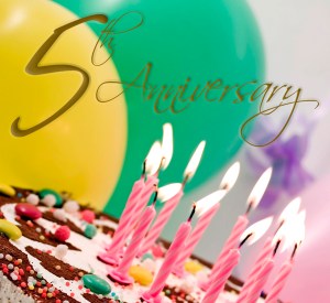 birthday cake with eleven candles, balloons at background